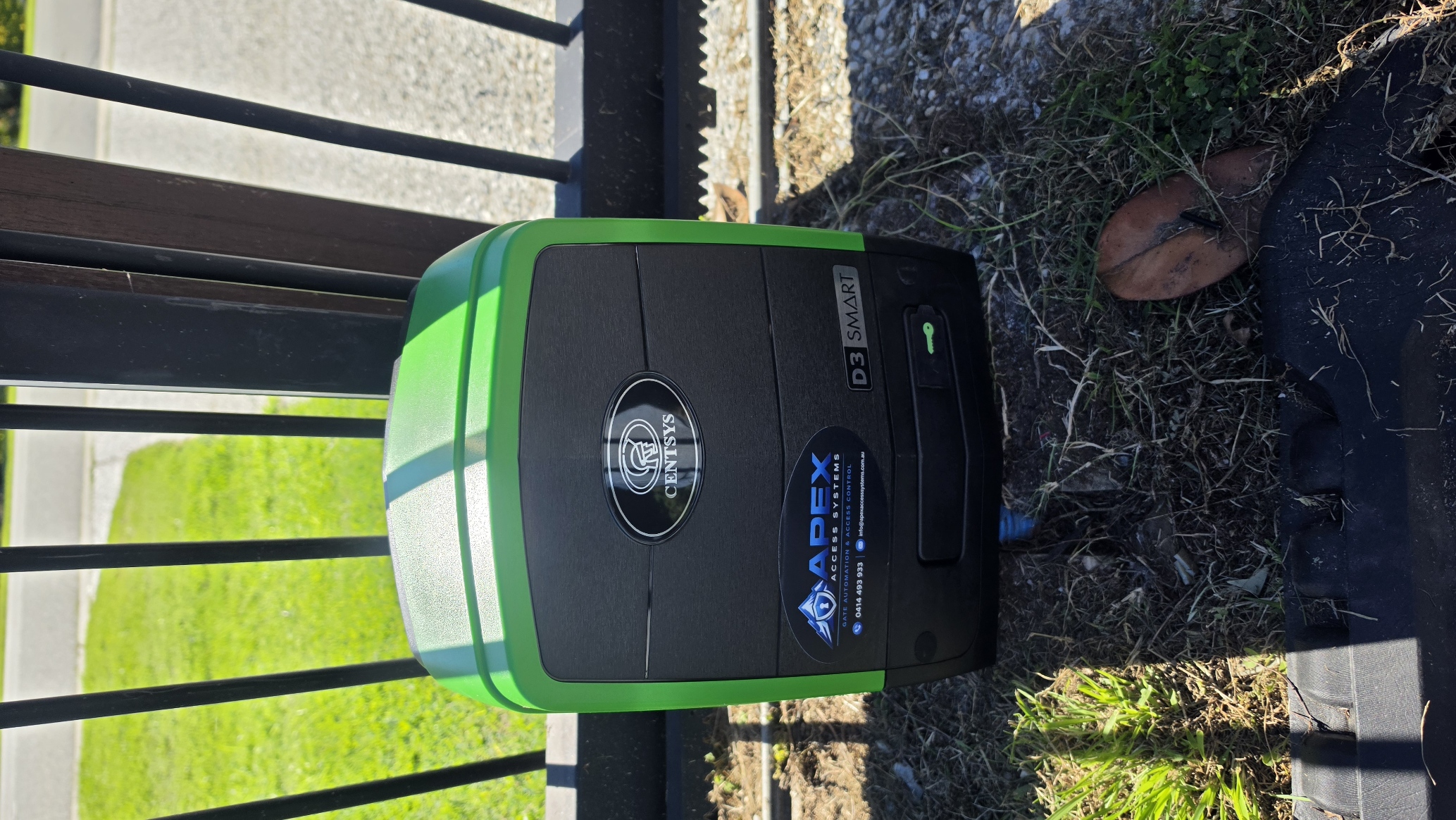 Finished automatic gate motor installation with Apex logo sticker